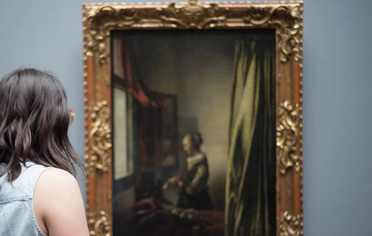 Photo of author at museum viewing a Vermeer